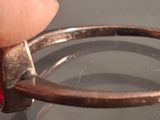 a person holding a ring that has been cut in half