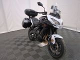 a motorcycle that is parked in a room with a checkered floor