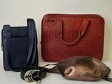two bags and a purse sitting on a table