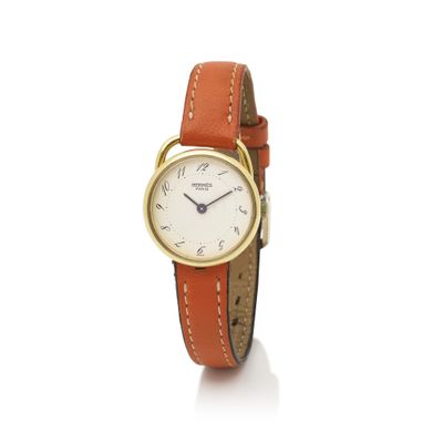 a close up of a wrist watch with an orange strap