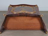 a large wooden box with a gold decoration on it