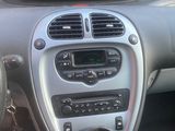 a dashboard of a car with a digital clock on it
