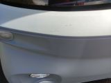 a close up of a car ' s rear end with the door open