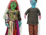 two dolls that are standing next to each other