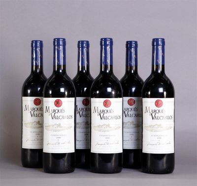 six bottles of red wine are lined up in a row