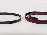 pair of black and burgundy leather bracelets with gold clasps
