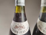 two bottles of wine sitting next to each other on a table