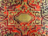 a red and gold book with gold writing on it