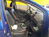a blue car that has a bunch of items in it