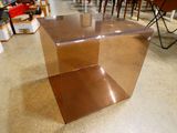 a brown table with a glass top in a store