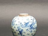 a blue and white vase with a bird on it
