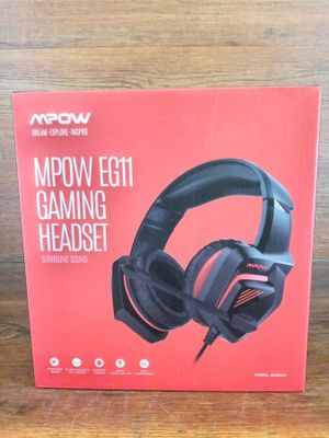 a box with a pair of headphones sitting on top of a wooden table
