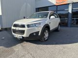 Le SUV blanc est garé devant un immeuble.