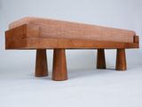 a wooden bench with three wooden legs on a white background