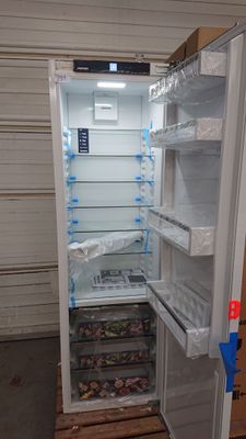 an open refrigerator with its door open in a garage
