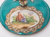 a blue plate with a picture of a woman and a bird on it