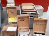 several boxes of mail sitting on the ground next to a red wall