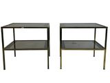 a pair of black glass and brass side tables