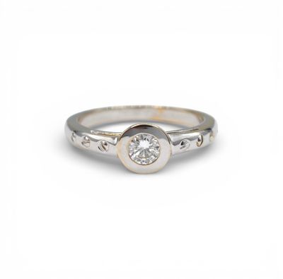 a close up of a diamond ring on a white background