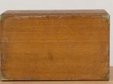 an old wooden box sitting on top of a table next to a white wall