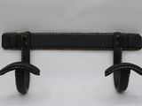 pair of black leather wall hooks on a white wall