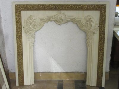 a marble fireplace surround in a room with a tile floor