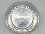a close up of a silver plate on a table