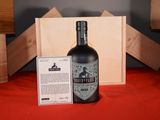 a bottle of liquor sitting next to a box of wine