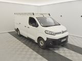 a white van parked in a room with a checkered floor