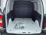 the back of a white van with a bed in the back