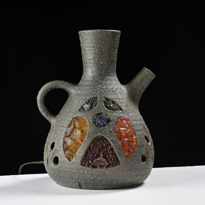 a gray vase with a multicolored design on it
