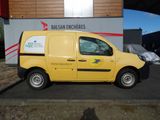 a small yellow van parked in front of a building