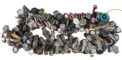 a pile of assorted watches on a white surface