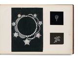 a black and white photo of a book with a picture of a necklace