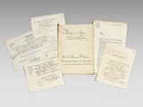 several old papers with writing on them sitting next to each other