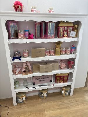 a white bookcase with lots of books on it