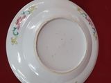 two plates and a bowl on a red table