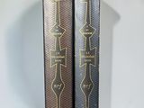 two books sitting on top of each other on a table