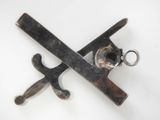 a pair of scissors and a wrench on a white surface