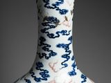 vase with blue and white designs on the outside of it