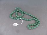 collier composé de perles de jade vert, muni d'une étiquette