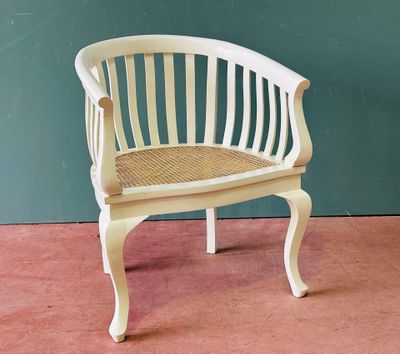 a white chair that is sitting on a pink floor