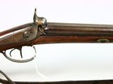 an old rifle with a wooden barrel and a metal handle