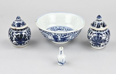 a blue and white bowl and two small vases