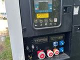 a machine that is sitting in the grass by the street