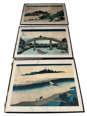 three japanese woodblock paintings of boats on a river and mountains
