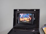 a video game in a black case next to a video game