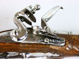 a close up of an old flintet with a man on it