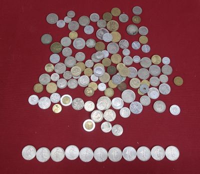 a pile of coins on a table with a red background