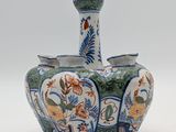 a blue and white vase with a bird on it